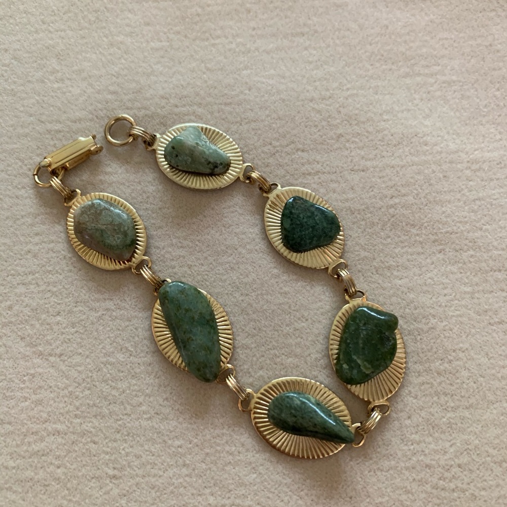 Vintage gold bracelet with green stones.